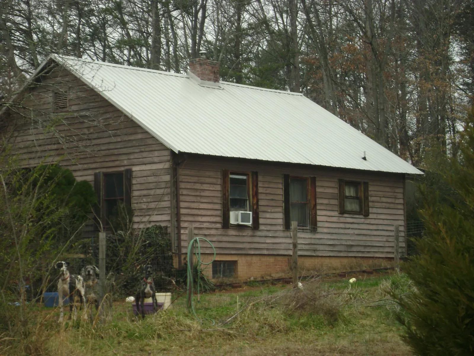 White metal roof on an old wood sided farmhouse, from a Metal Roof Installation job in Canistota